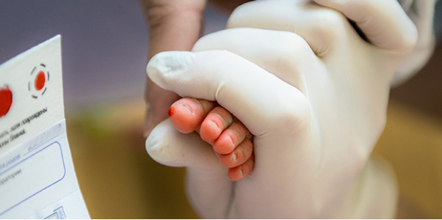 Clinician holding newborn foot
