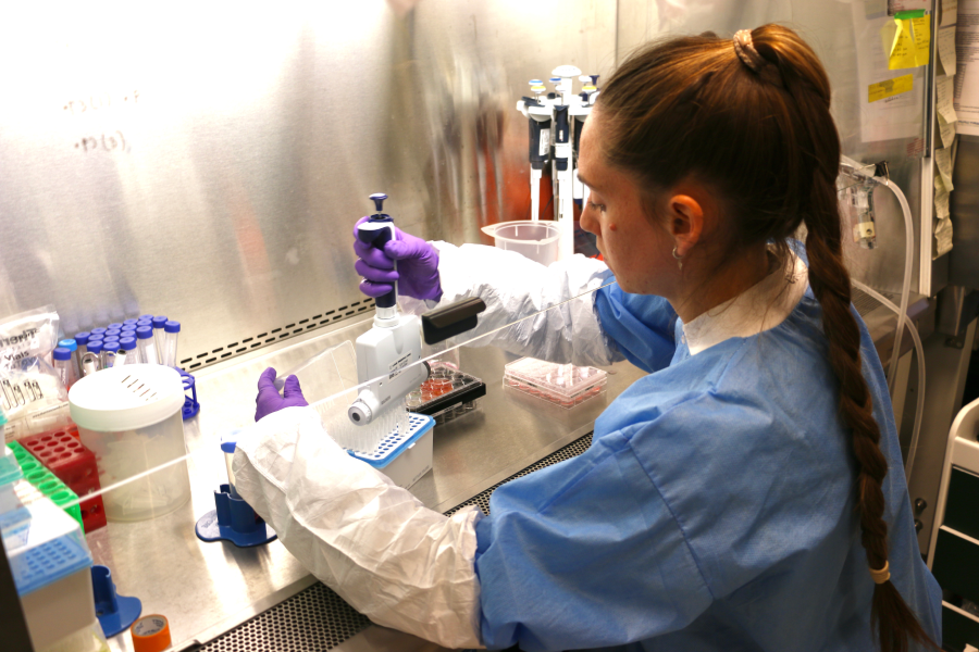Researcher working with a 3-D bioprinter.