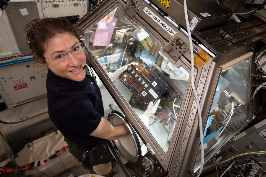 NASA astronaut Christina Koch assists with the kidney tissue chip project on board the International Space Station. 