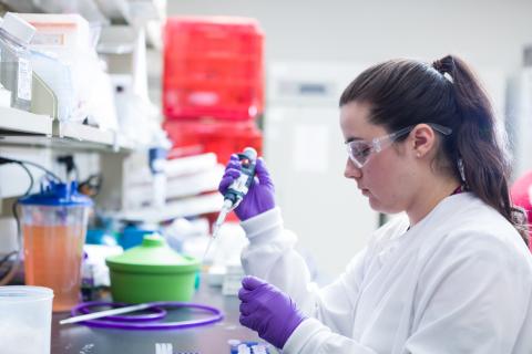 A researcher works inside a lab.